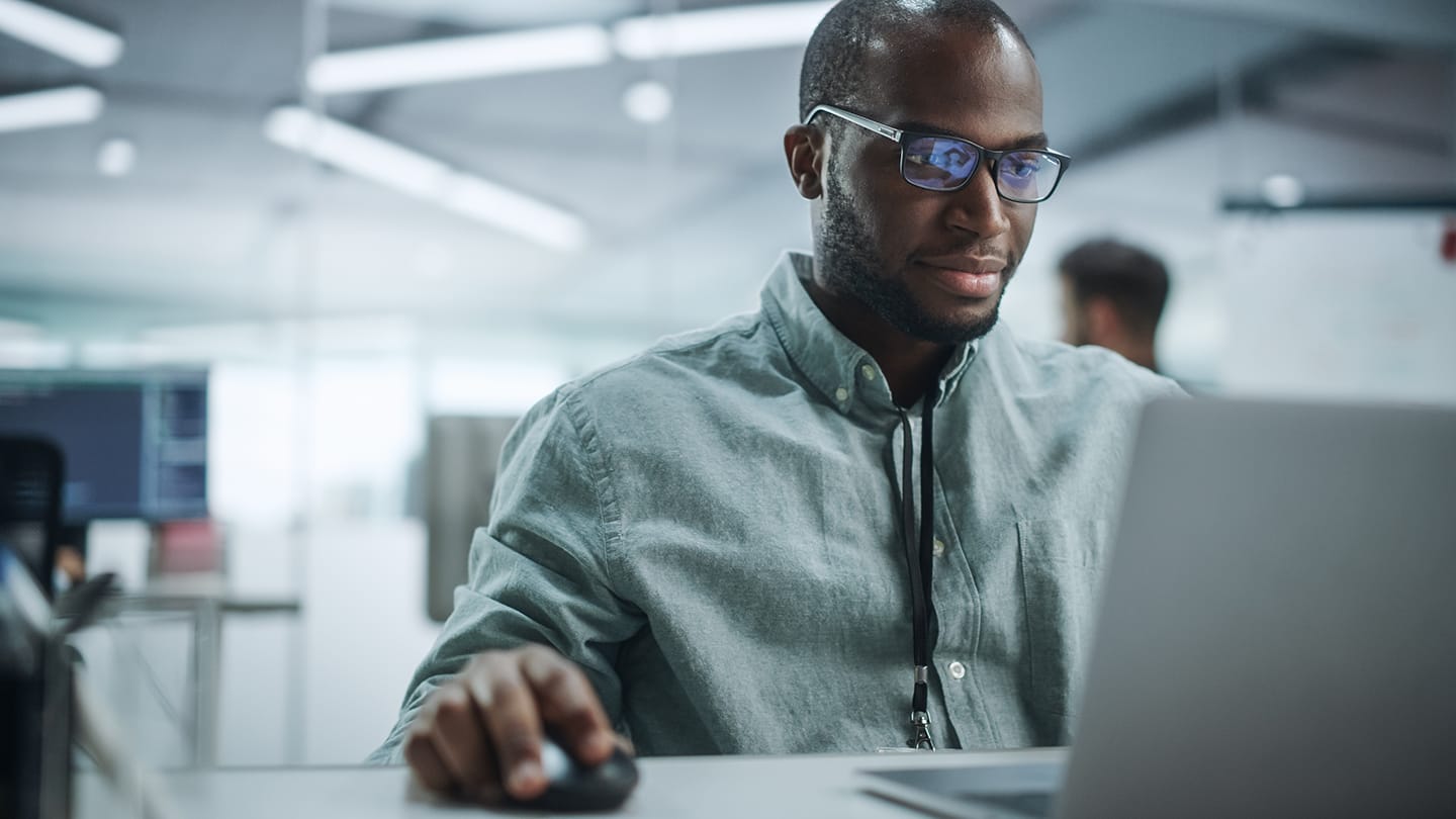 A cloud architect learns about the power of cloud-native content services as they read an e-book on their laptop.